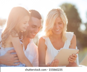 summer holidays, children and people concept - happy family with tablet pc taking picture - Powered by Shutterstock