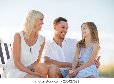 Summer Holidays, Children And People Concept - Happy Family Having A Picnic