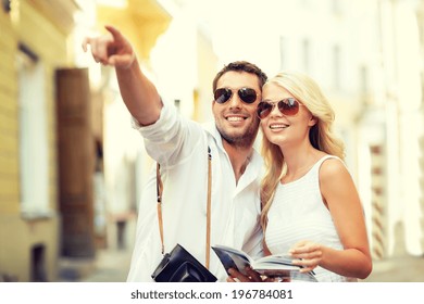 Summer Holidays, Dating, City Break And Tourism Concept - Couple With Camera And Travellers Guide