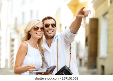 Summer Holidays, Dating, City Break And Tourism Concept - Couple With Camera And Travellers Guide