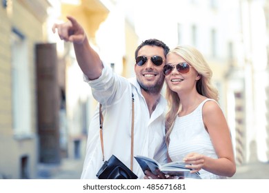 Summer Holidays, Dating, City Break And Tourism Concept - Couple With Camera And Travellers Guide