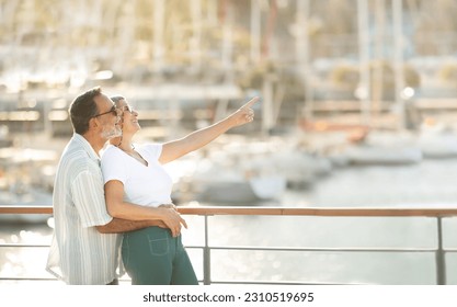 Summer Holidays. Joyful Retired European Spouses Looking At Luxury Yachts In Marina, Pointing Finger Aside At Empty Space Standing At Pier Outside. Seniors Advertising Vacation Tour Offer - Shutterstock ID 2310519695