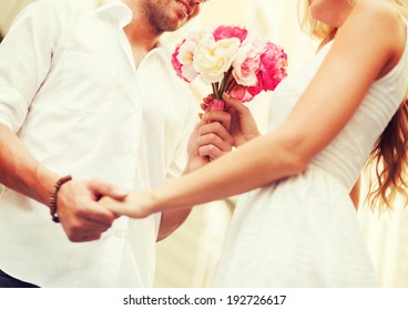 summer holidays, love, relationship and dating concept - couple with bouquet of flowers in the city - Powered by Shutterstock