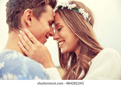 summer holidays, love, romance and people concept - happy smiling young hippie couple hugging outdoors - Powered by Shutterstock