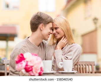 summer holidays, love, travel, tourism, relationship and dating concept - romantic happy couple kissing in the cafe - Powered by Shutterstock