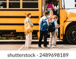 Summer holidays are over.Schoolchildren kids pupils group of mixed race classmates boarding school bus before going to lessons, coming back to school, standing in line. New educational year semester.