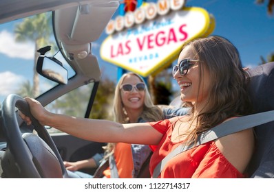 Summer Holidays, Road Trip And Travel Concept - Happy Young Women Driving In Convertible Car And Laughing Over Welcome To Fabulous Las Vegas Sign Background