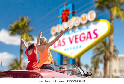 Summer Holidays, Road Trip And Travel Concept - Happy Friends Driving In Convertible Car And Waving Hands Over Welcome To Fabulous Las Vegas Sign Background