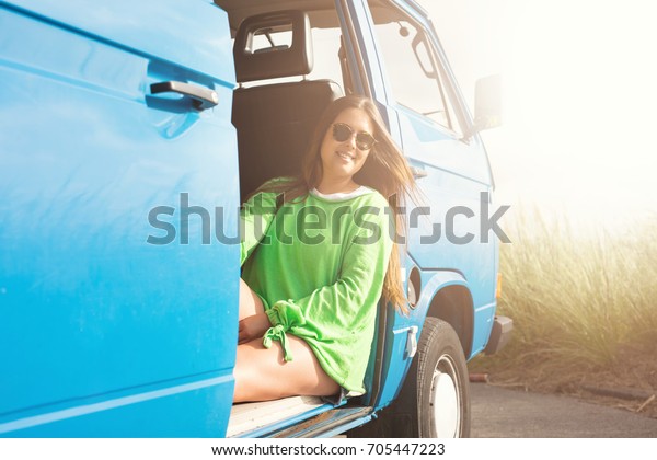 summer holidays, road trip, travel and\
people concept, young woman resting in minivan\
car