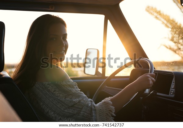 summer holidays, road trip, travel and
people concept, young woman resting in minivan
car