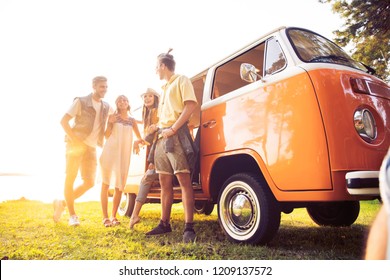 Summer holidays, road trip, vacation, travel and people concept - smiling young hippie friends having fun over minivan car - Powered by Shutterstock