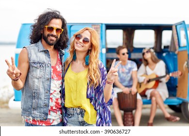 Summer Holidays, Road Trip, Vacation, Travel And People Concept - Smiling Young Hippie Friends Over Minivan Car Showing Peace Hand Sign