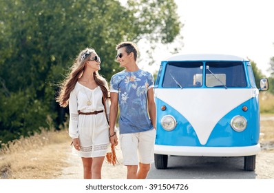 summer holidays, road trip, vacation, travel and people concept - smiling young hippie couple talking over minivan car - Powered by Shutterstock