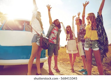 Summer Holidays, Road Trip, Vacation, Travel And People Concept - Smiling Young Hippie Friends Having Fun Over Minivan Car