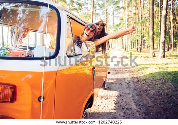 summer holidays,
road trip, vacation, travel and people concept - Hipster friends on
road trip on a summers
day