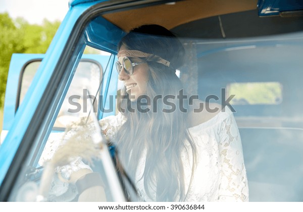 summer holidays, road\
trip, vacation, travel and people concept - smiling young hippie\
women in minivan car