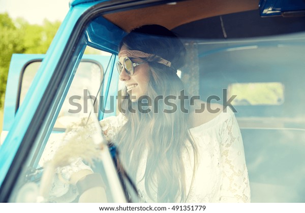 summer holidays, road
trip, vacation, travel and people concept - smiling young hippie
women in minivan car
