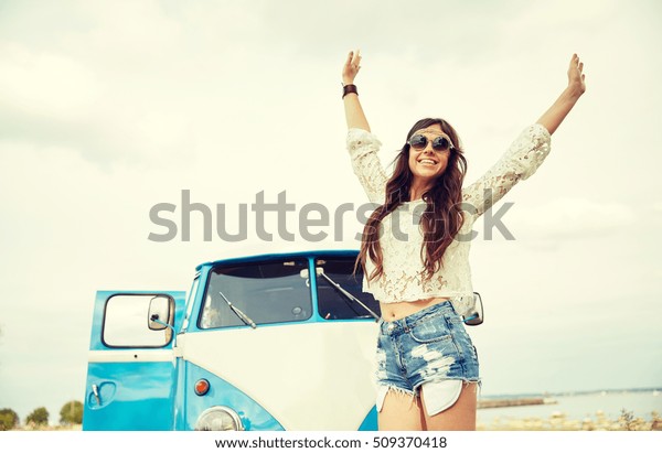 summer holidays, road\
trip, vacation, travel and people concept - smiling young hippie\
women in minivan car