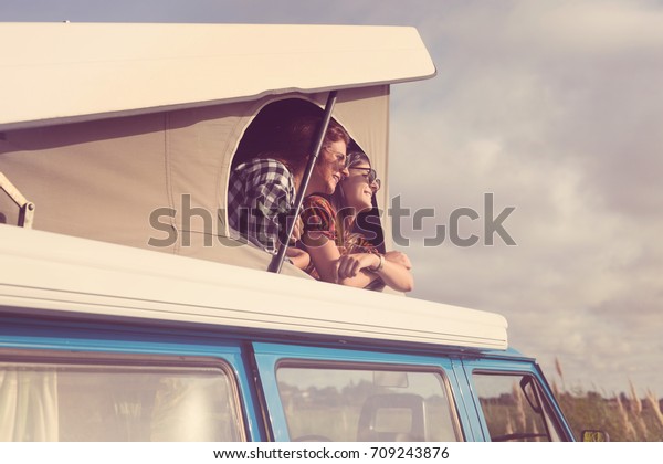 Summer holidays, road trip,
vacation, travel and people concept - smiling young hippie women in
car