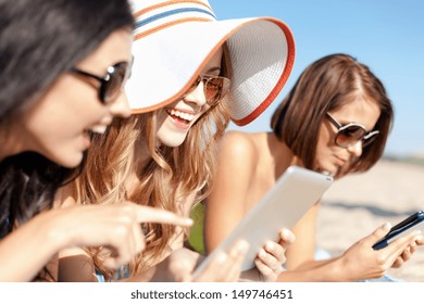 summer holidays, technology and internet concept - girls in bikinis with tablet pc sunbathing on the beach - Powered by Shutterstock