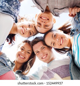 summer holidays and teenage concept - group of teenagers looking down - Shutterstock ID 152449937