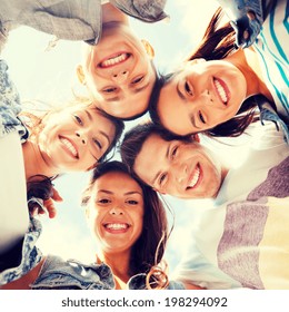 summer holidays and teenage concept - group of teenagers looking down - Shutterstock ID 198294092