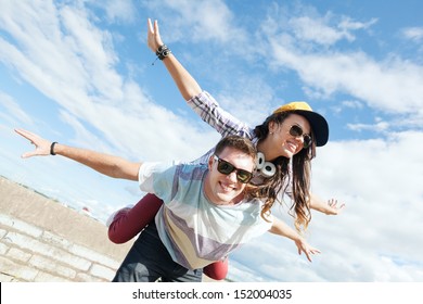 Summer Holidays And Teenage Concept - Teenagers Having Fun Outside