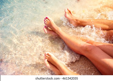 Summer Holidays, Vacation Concept. Family Sitting On Sandy Beach In Water. Bare Feet. 