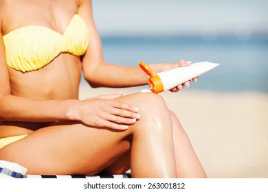 Summer Holidays And Vacation - Girl Putting Sun Protection Cream On The Beach Chair