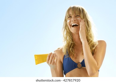 Summer Holidays And Vacation - Girl Putting Sun Protection Cream At The Beach