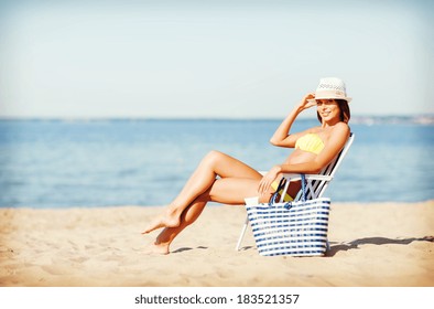 summer holidays and vacation - girl sunbathing on the beach chair