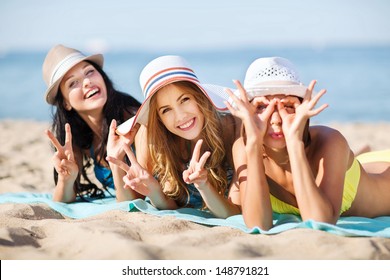 summer holidays and vacation - girls sunbathing on the beach - Powered by Shutterstock