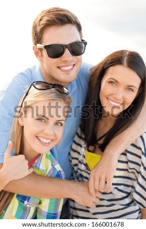 summer, holidays, vacation and happiness concept - group of friends having fun on the beach