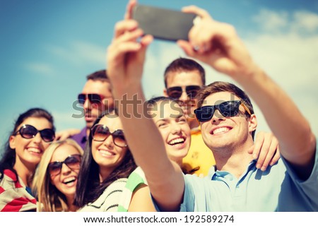 summer, holidays, vacation and happiness concept - group of friends taking selfie with smartphone