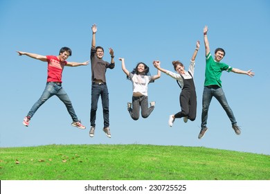 summer, holidays, vacation, happy people concept - group of friends jumping on the park