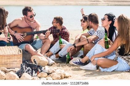 Summer, Holidays, Vacation, Music, Happy People Concept - Group Of Friends With Guitar Having Fun On The Beach Making BBQ And Drinking Beer