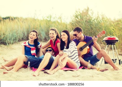 summer, holidays, vacation, music, happy people concept - group of friends with guitar having fun on the beach - Powered by Shutterstock