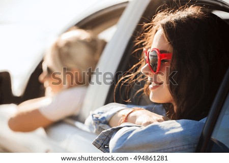 Similar – Two young women resting sitting inside of car