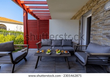 Summer house terrace. Beautiful terrace with breakfast prepared at dawn next to the garden