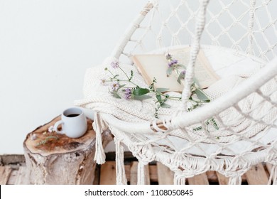 Summer Hygge Scene With Hammock Chair, Book And Flowers. Cozy Place For Weekend Relax In The Garden.