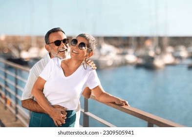 Summer Joy. Senior Couple Posing Near Yachts and Sailboats Embracing And Laughing At Marina Pier Outdoor On Sunny Day. Seniors Enjoying Holidays Together At Seaside. Empty Space - Powered by Shutterstock