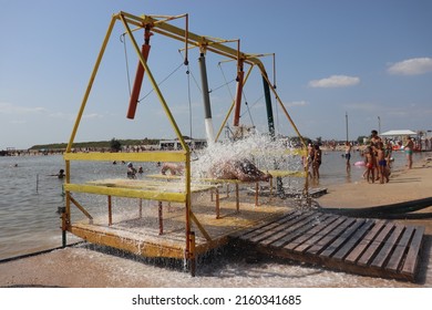 summer July 2021, Ukraine, Kherson region, genichesky district, Arabat spit, salt lake, hydromassage installation on the shore in the process of massage.