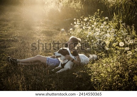 Similar – Image, Stock Photo Blond woman walking her dogs at sunset