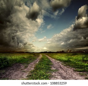 Summer landscape with green grass, road and clouds - Powered by Shutterstock