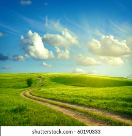 Summer Landscape With Green Grass, Road And Clouds