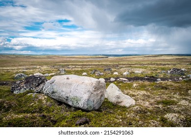 Summer Landscape Of The Green Polar Tundra With Boulders In The Foreground And Lake On The Horizon. Northern Nature In The Vicinity Teriberka (Kola Peninsula, Russia)