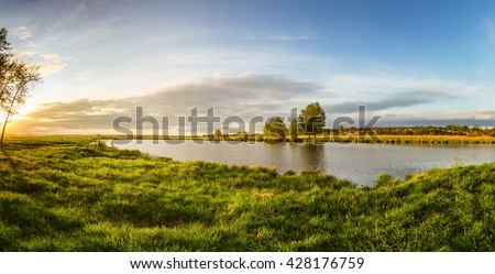 summer landscape on the banks of the green river at sunset, Russia, Ural