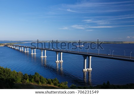 Summer landscape with river bridge and blue sky.