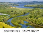 Summer landscape, river a large natural stream of water flowing in a channel to the sea, a lake, or another such stream. flood, nulla, effluent, ford. High hilly shores