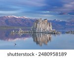 Summer landscape at sunrise of Mono Lake and Eastern Sierra Nevada Mountains with tufa formations and reflections in calm water, California, USA